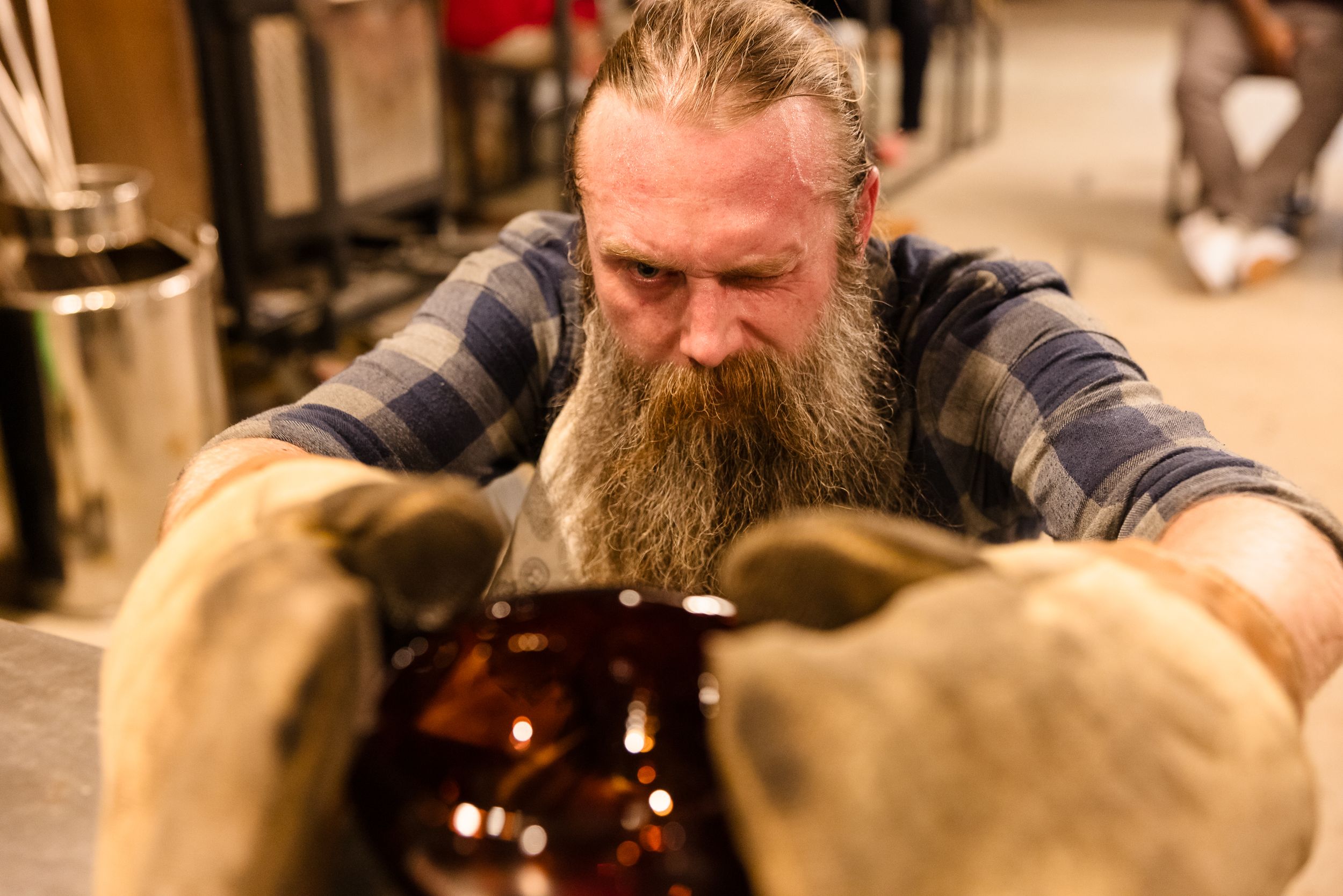 Artisans focus on detailed handwork at a well-equipped crafting station.