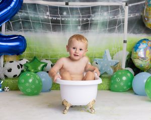 Image of little boy at his cake smash celebrating two year old birthday party in Coventry