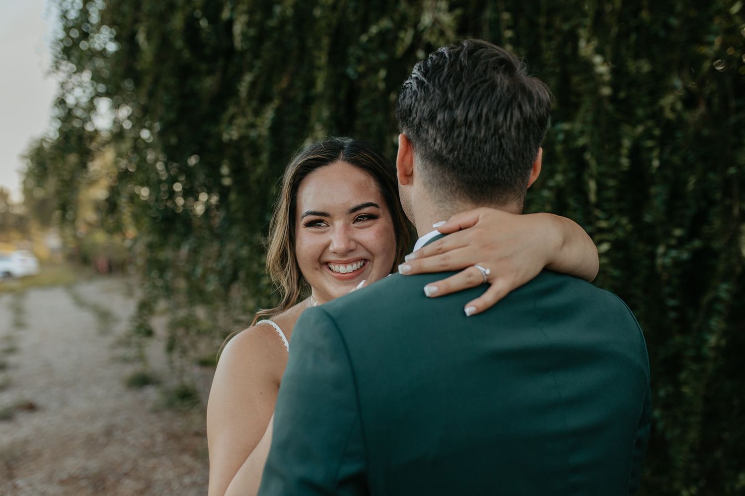 A couple shares an intimate moment during a romantic outdoor photoshoot in a natural setting at Canopy Grove by Wedgewood Weddings.
