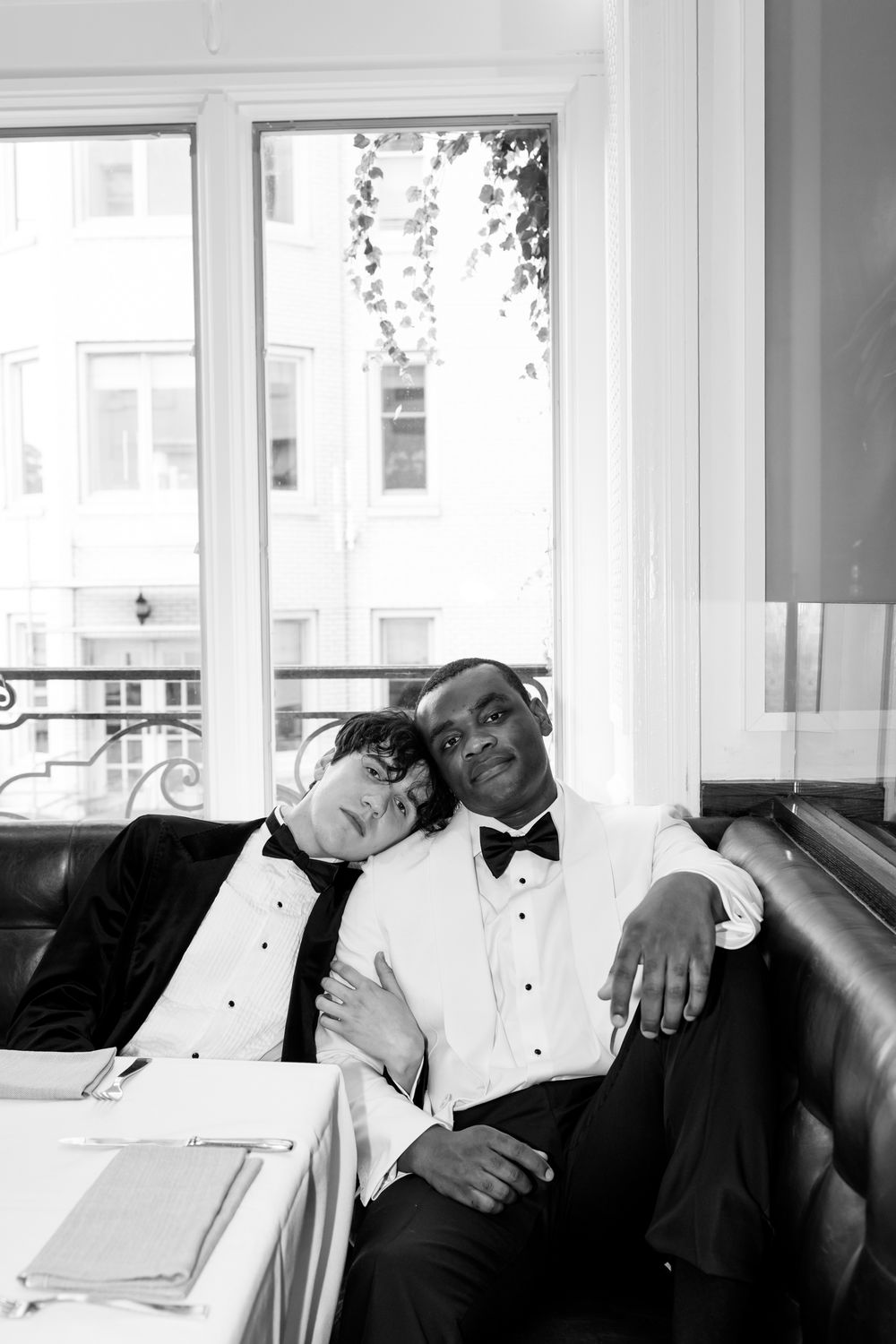 A series of black and white photographs showing a couple in formal attire resting on a couch near windows.