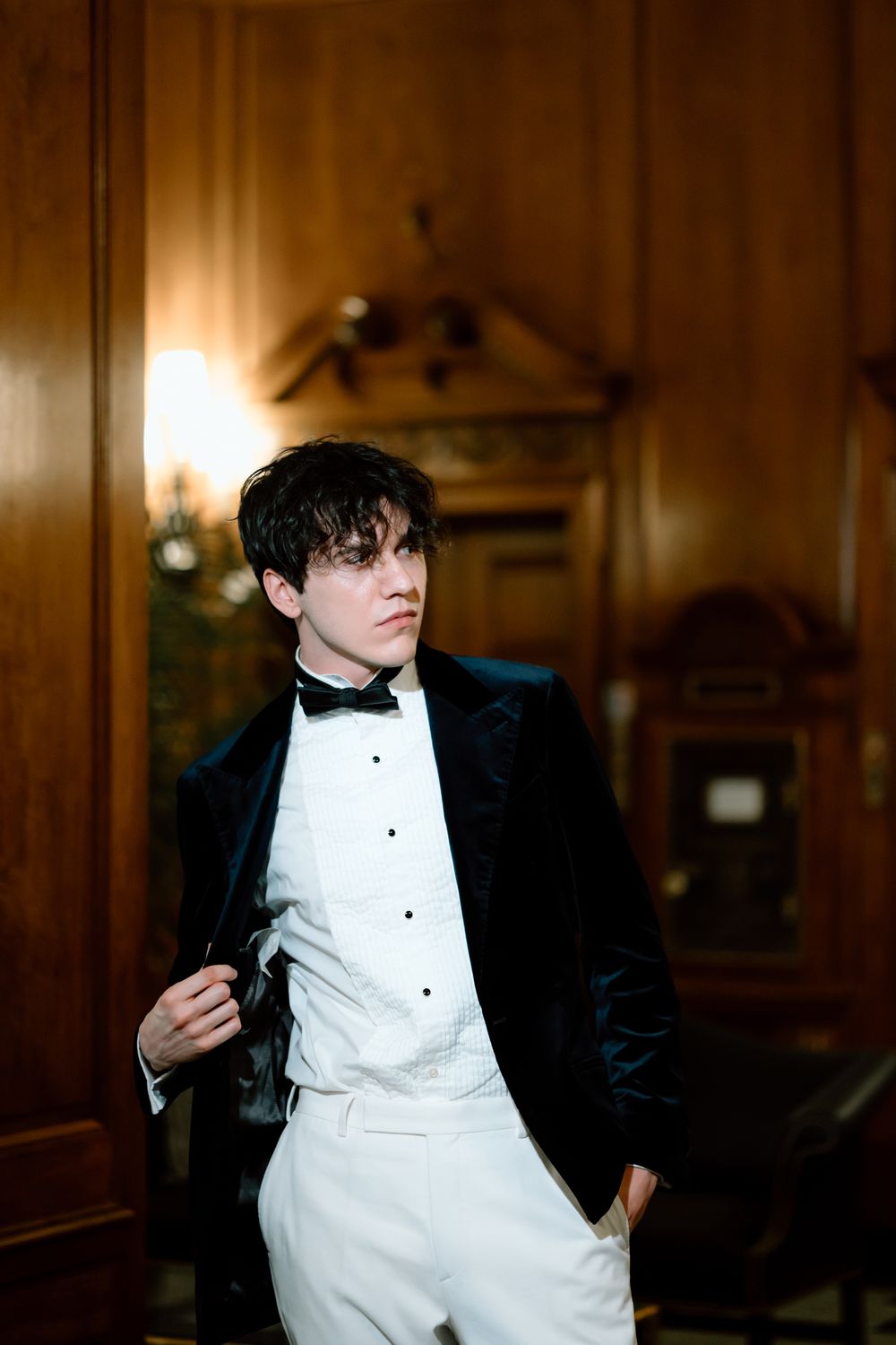 Person in formal attire photographed in sequence against wood-paneled interior.
