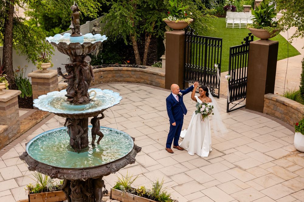 Elegant stone patio with decorative fountain and wedding decor at outdoor venue.