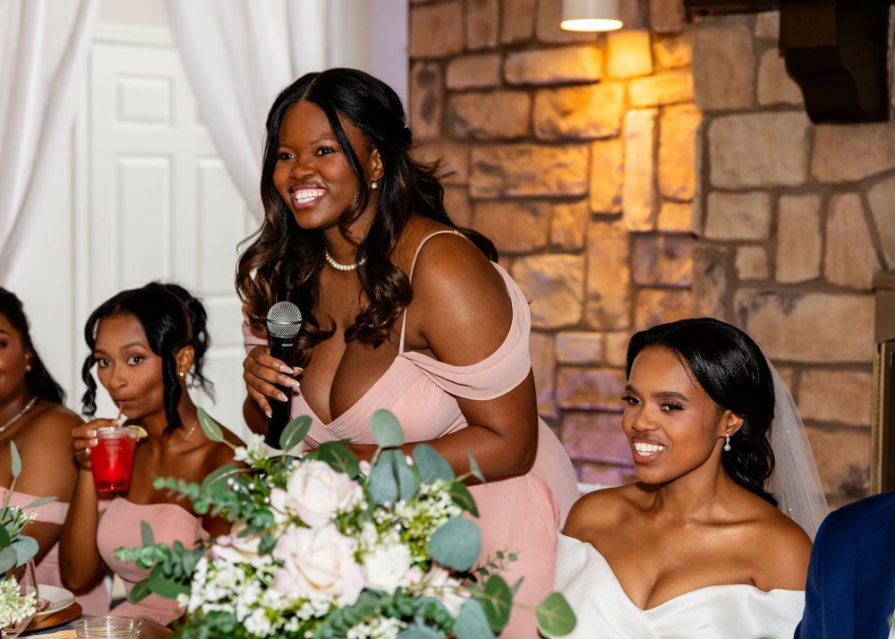 Wedding reception dinner with elegant table settings and floral decorations.
