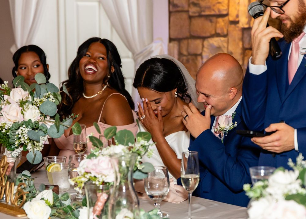 Wedding reception celebration with guests seated at decorated tables.