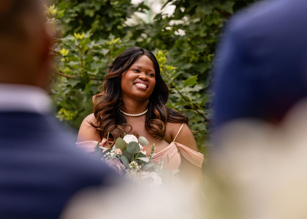 Wedding ceremony candid moments captured under natural greenery.