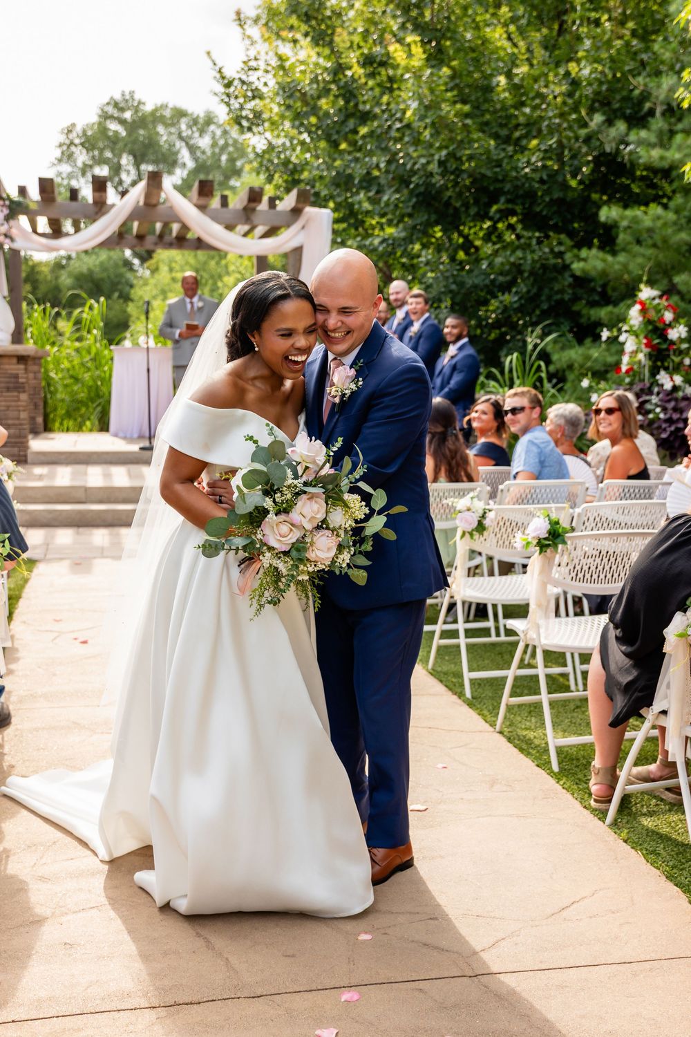 Candid moments of joy and celebration during outdoor wedding ceremony at Villa Aletta in Omaha, NE.