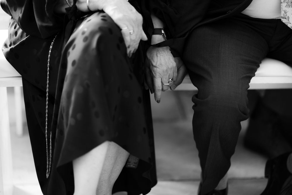 Black and white photo of wedding guests gathered in formal attire. Woodhill Hall.