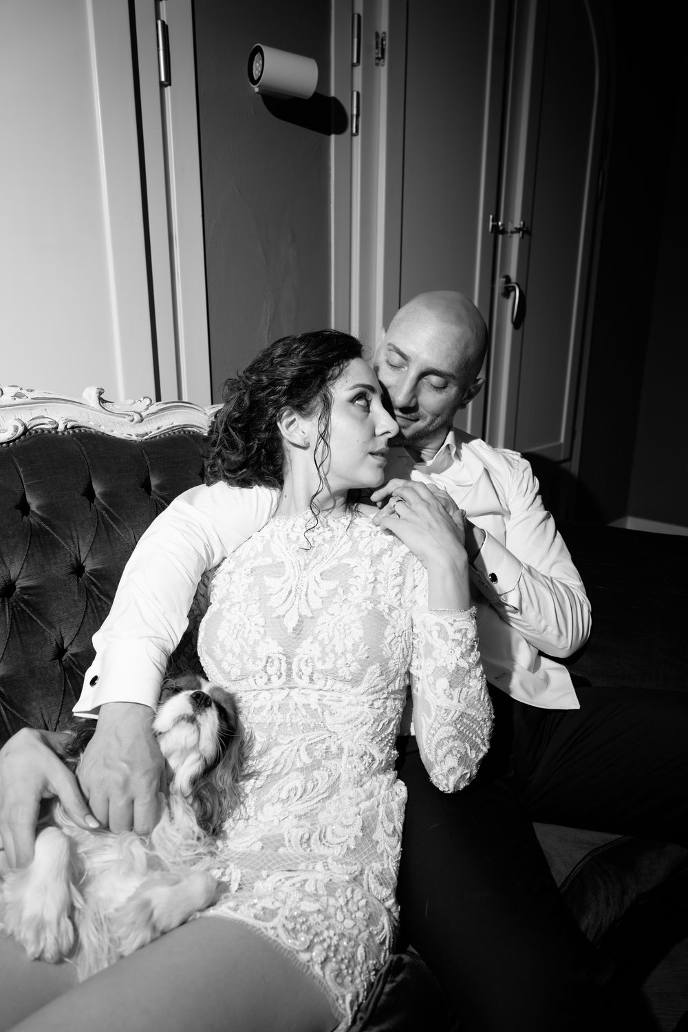 A romantic black and white photo series showing tender moments between a couple in formal wedding attire.