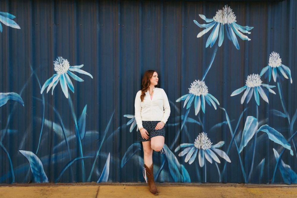 A sequence of photos showing someone dancing against a blue wall with white floral artwork in the background.