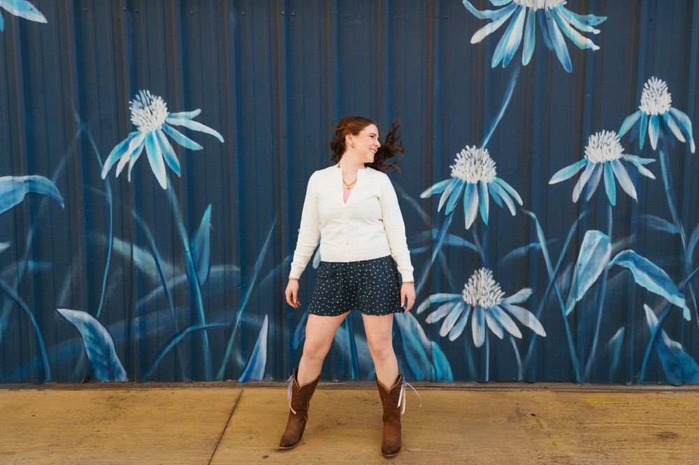 A series of images showing a person in a dark room with blue floral wall art and dramatic lighting.