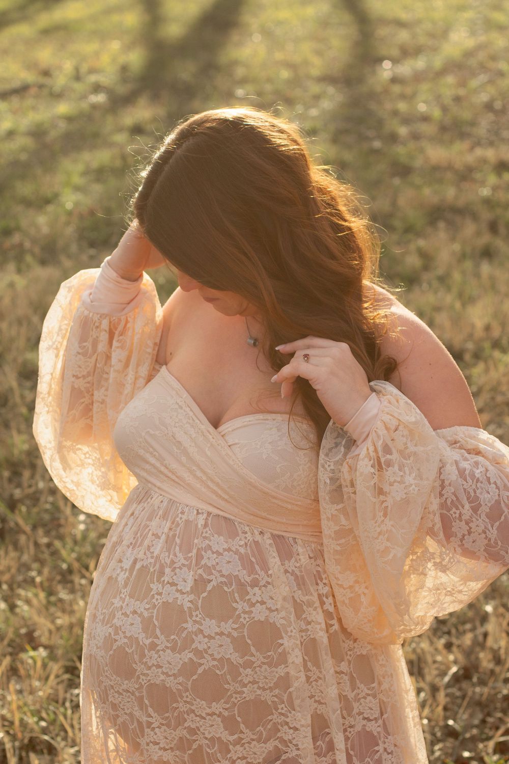 photo of a pregnant woman wearing a romantic lace dress