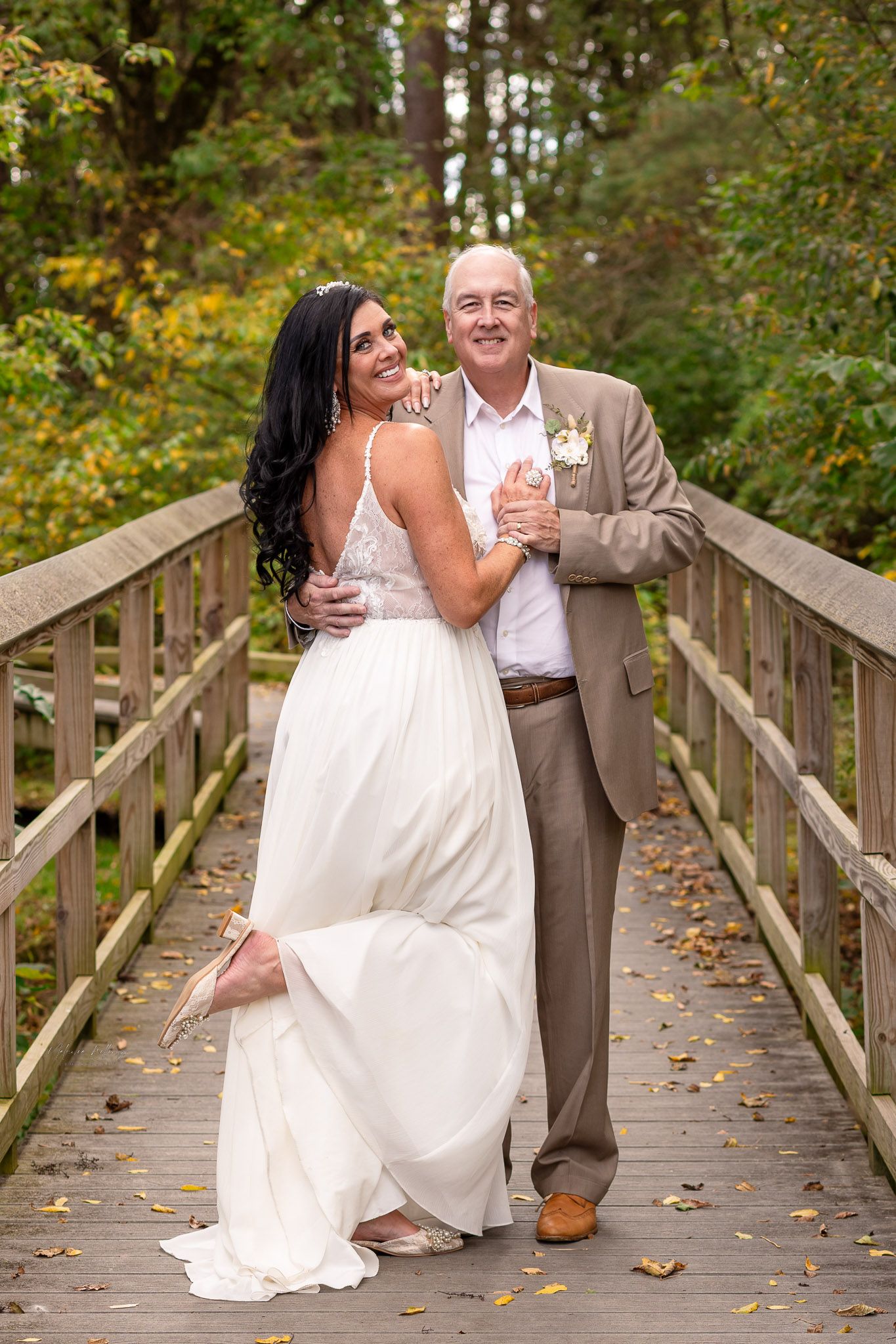 Bride and groom portrait on wooden bridge after intimate wedding in Frederick Maryland