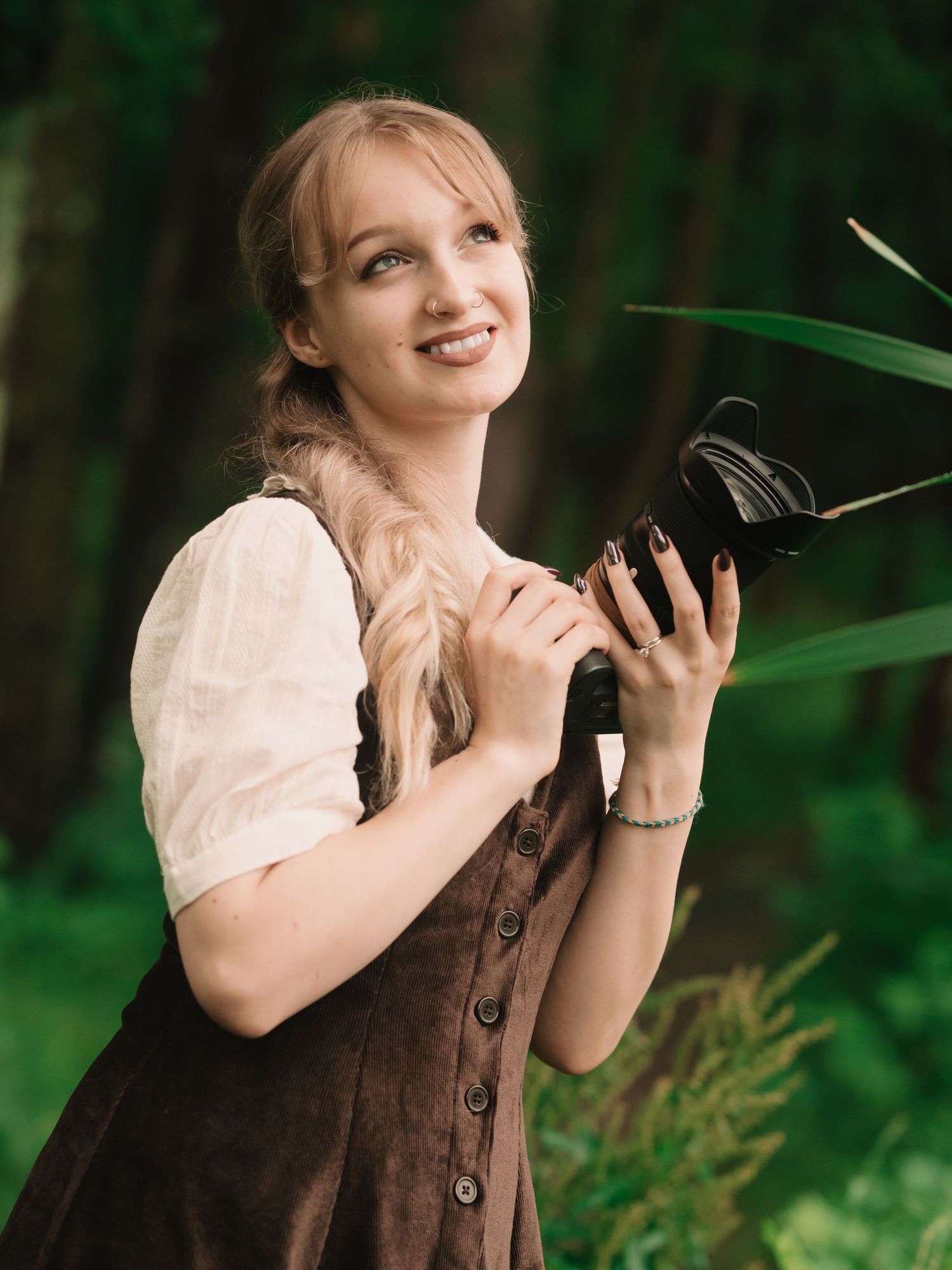 Emma Cayea, photographer and owner of Emma Cayea Photography, posing outdoors for a personal portrait during golden hour