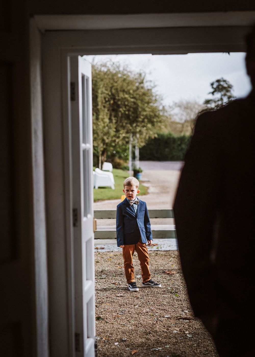 A sequence of photos showing someone walking down a gravel path viewed through an open doorway.