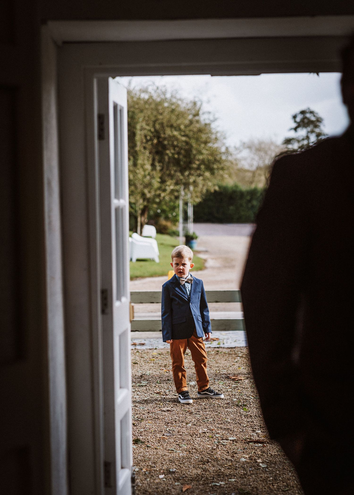 A sequence of photos showing someone walking down a gravel path viewed through an open doorway.
