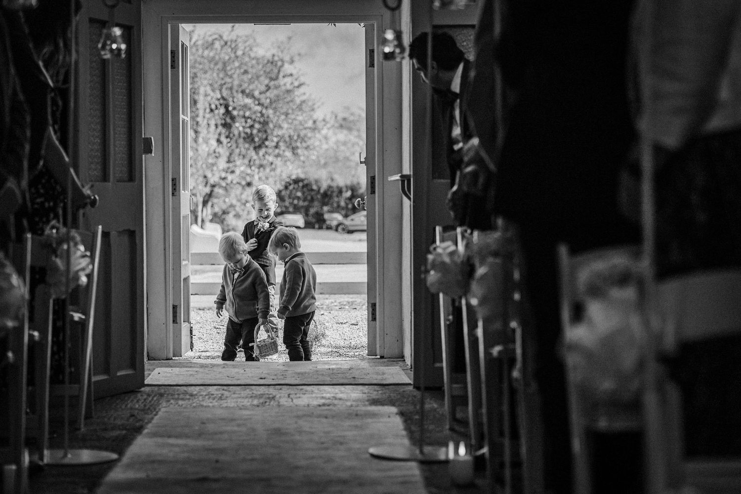 A series of black and white photographs showing silhouettes of people walking through doorways and corridors.