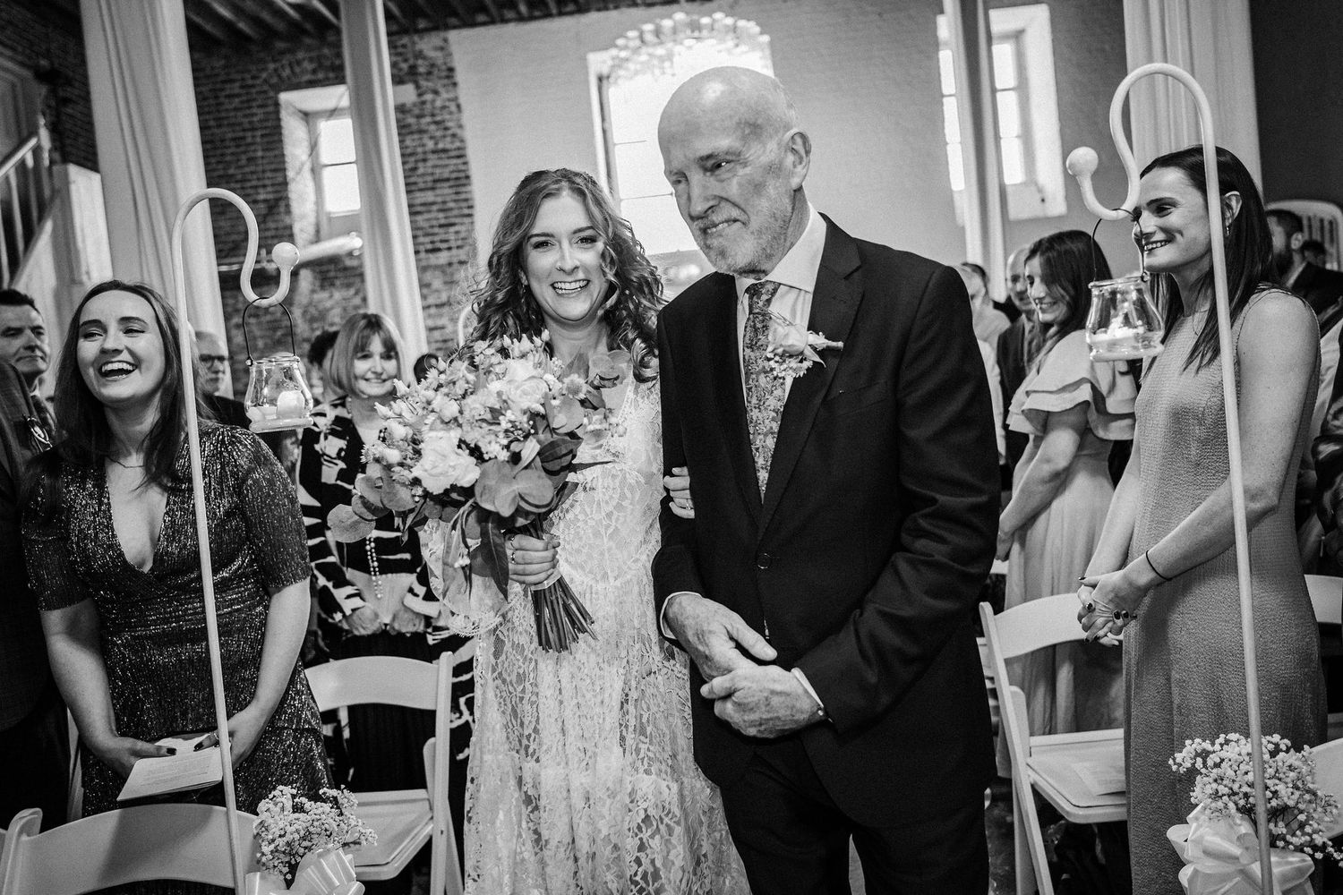 Black and white photos capture candid moments between guests during an indoor wedding celebration.