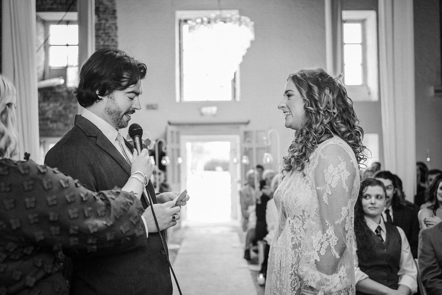 Black and white photograph showing a couple dancing together at a wedding reception.