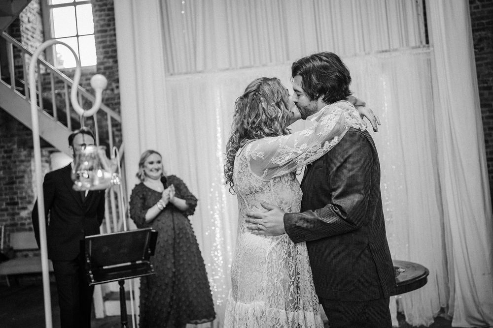 Black and white photo collage showing couples dancing at a wedding celebration in an elegant indoor venue.
