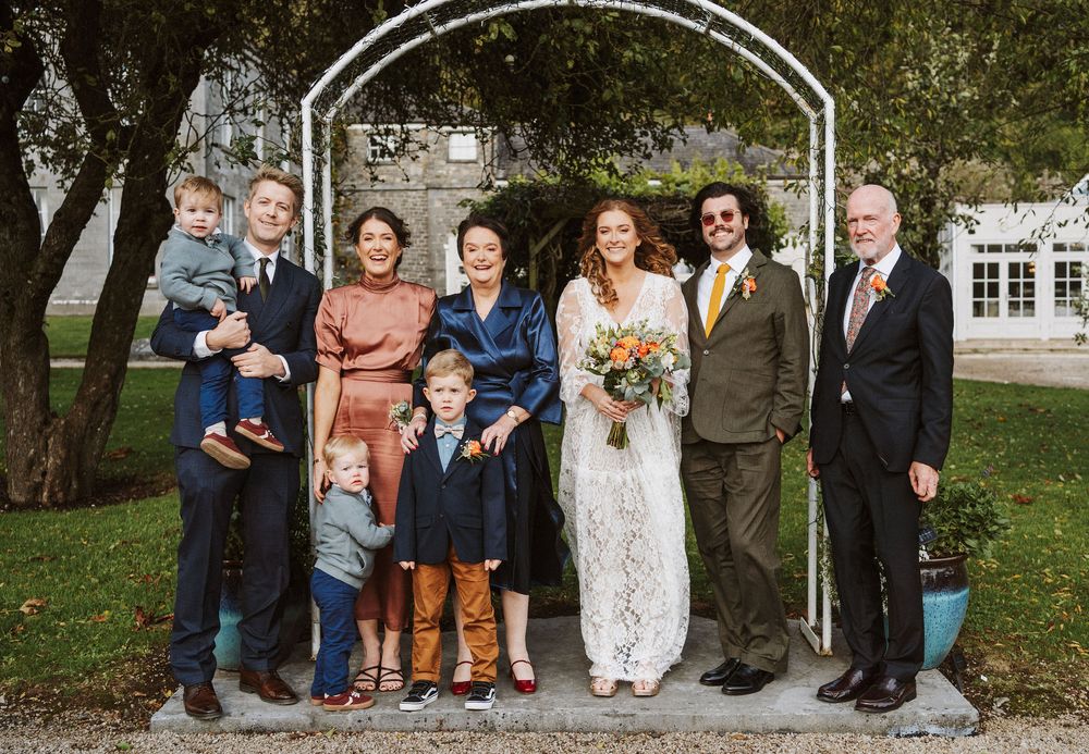 A panoramic collage of outdoor wedding photos showing groups of people posing together in a garden setting.