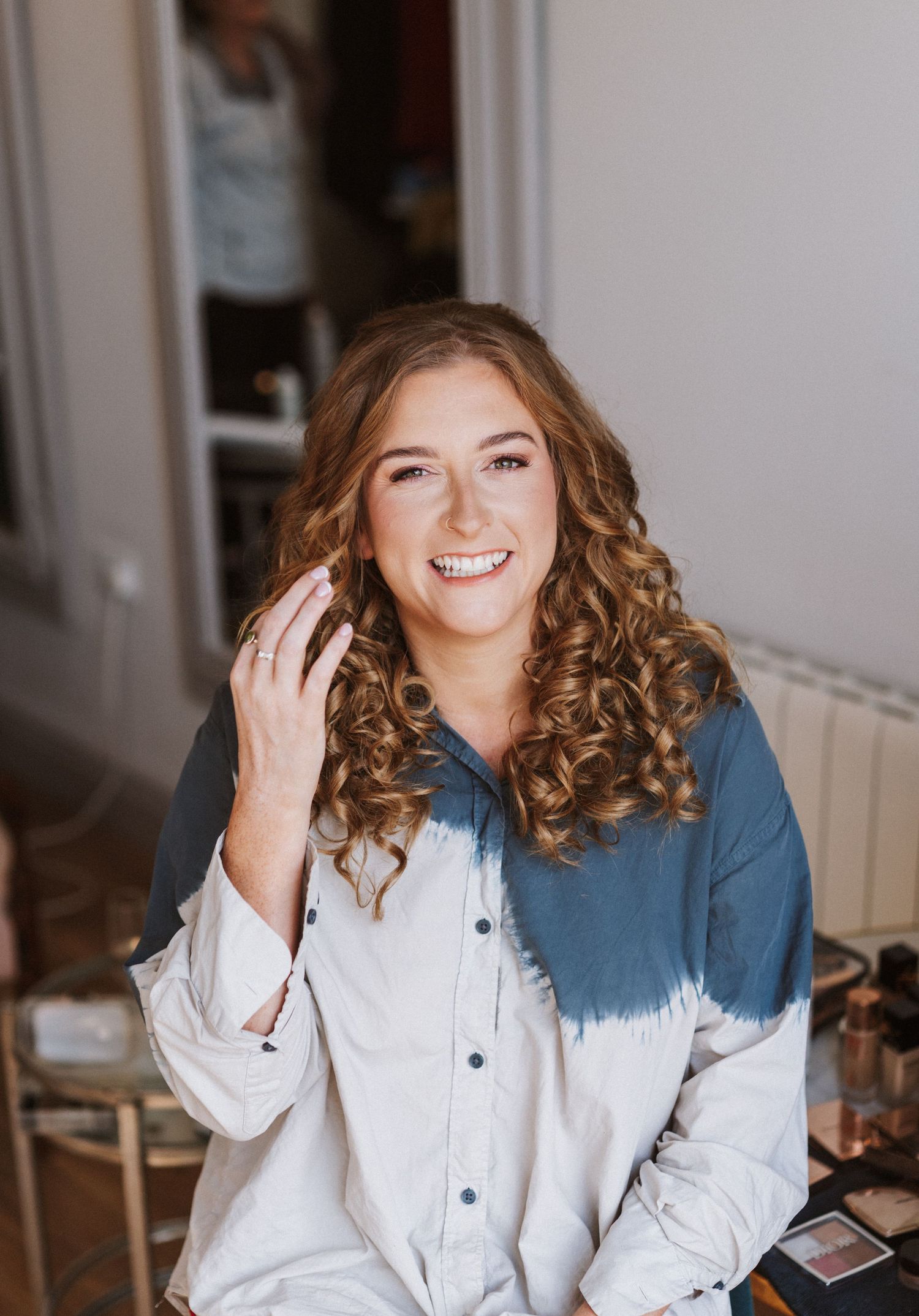 A series of four lifestyle photos showing a person in a white button-down shirt with curled hair against a light background.