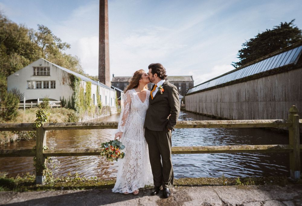 Couple shares romantic moments at scenic waterfront locations during a wedding photo session.
