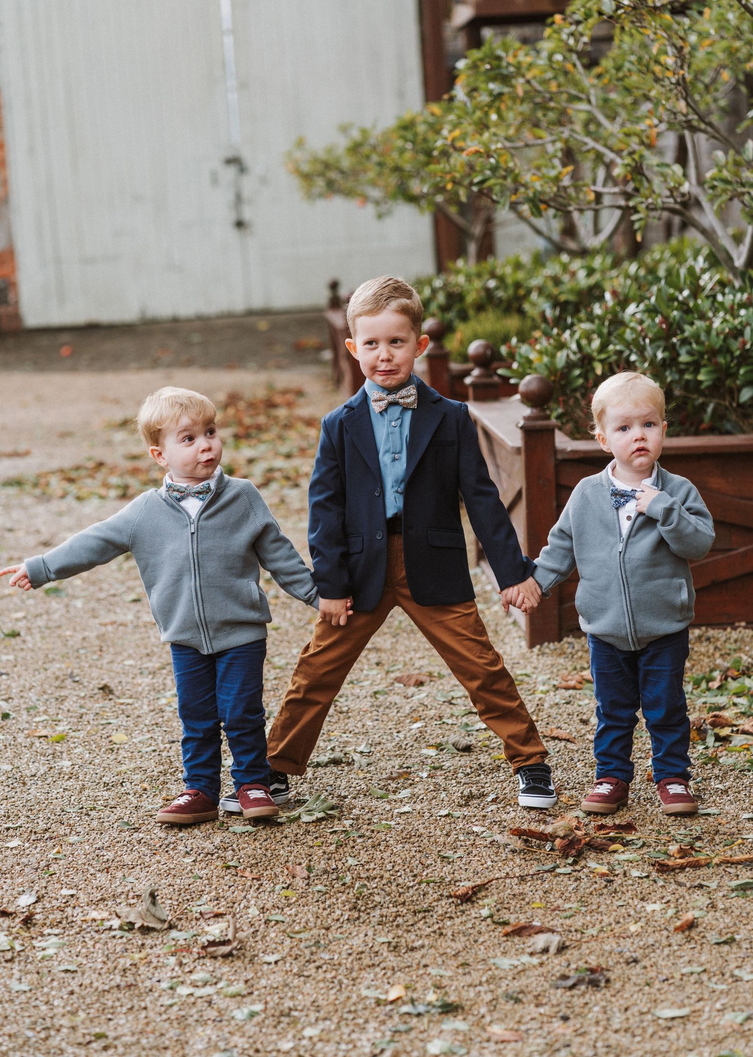 A sequence of photos showing a small child in a gray sweater and jeans playing and walking on gravel ground.