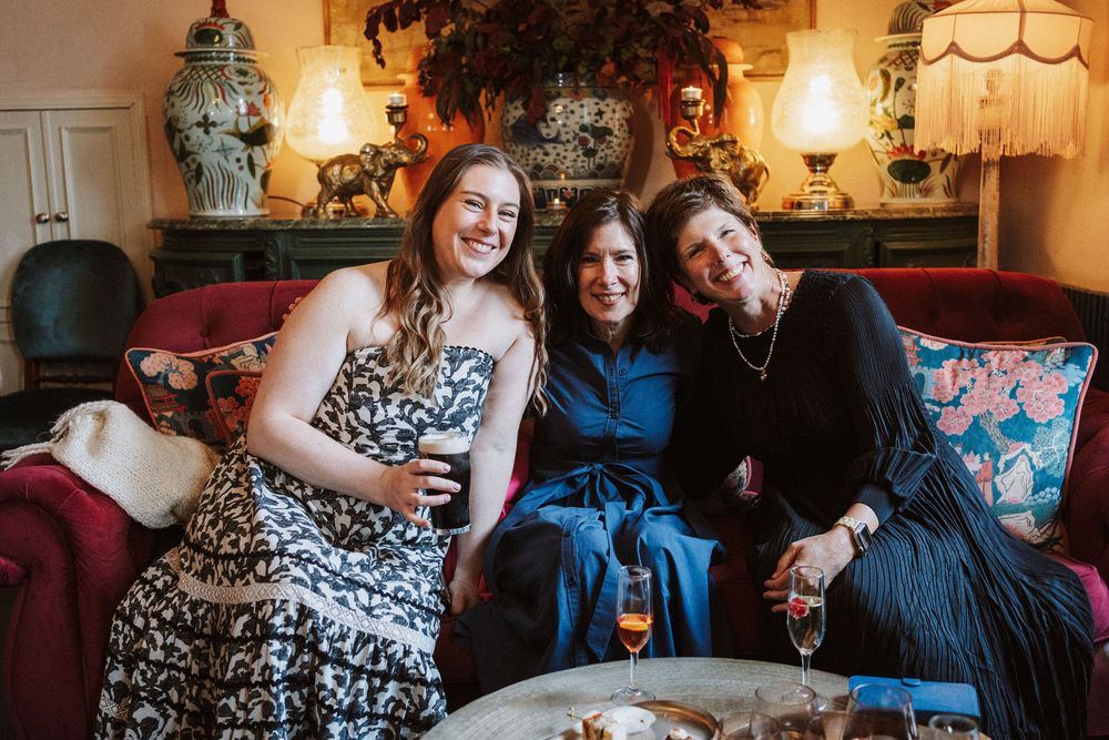 Candid moments captured during a celebration at an elegantly decorated indoor venue with warm lighting and vintage decor.