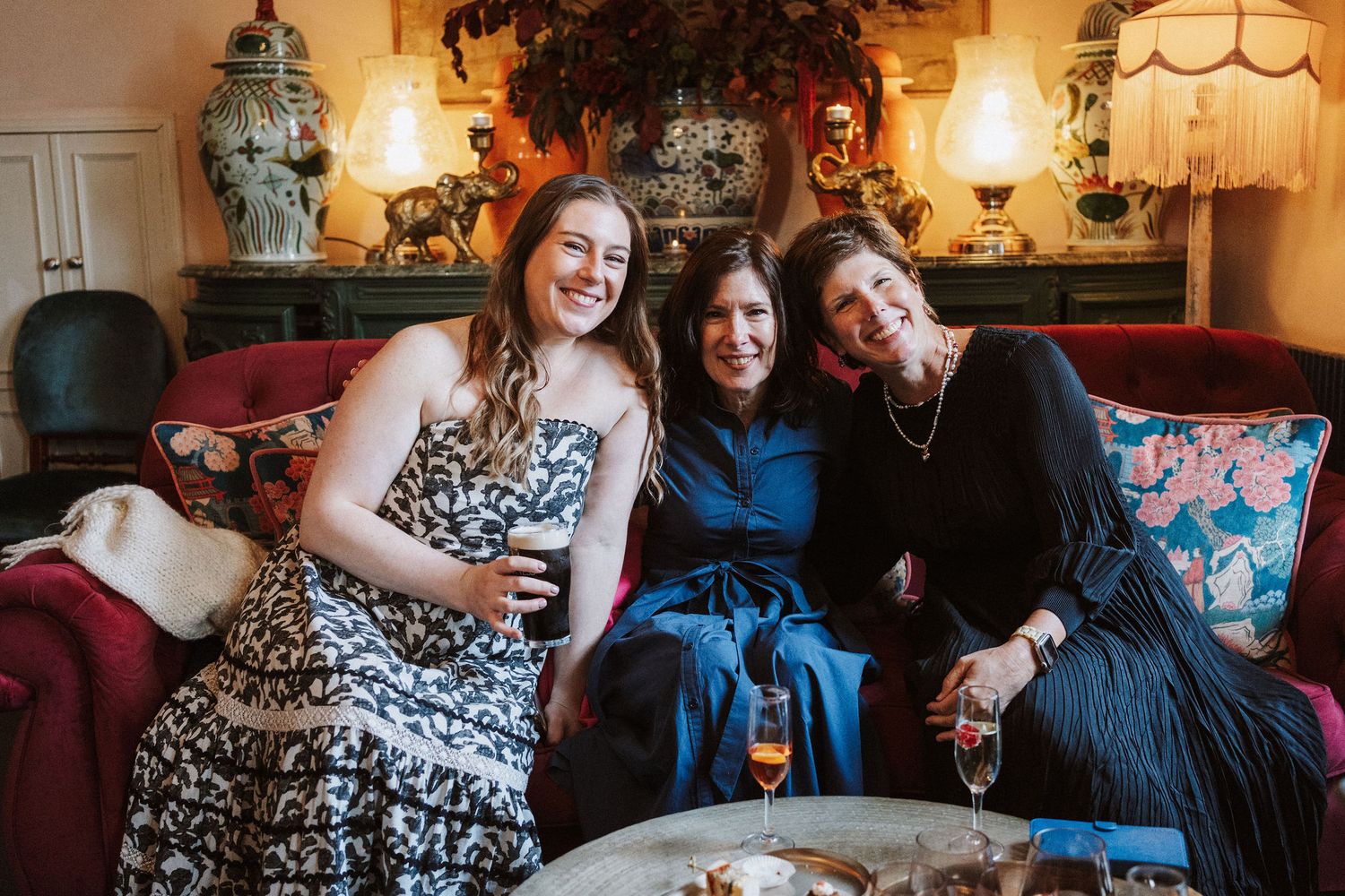 Candid moments captured during a celebration at an elegantly decorated indoor venue with warm lighting and vintage decor.