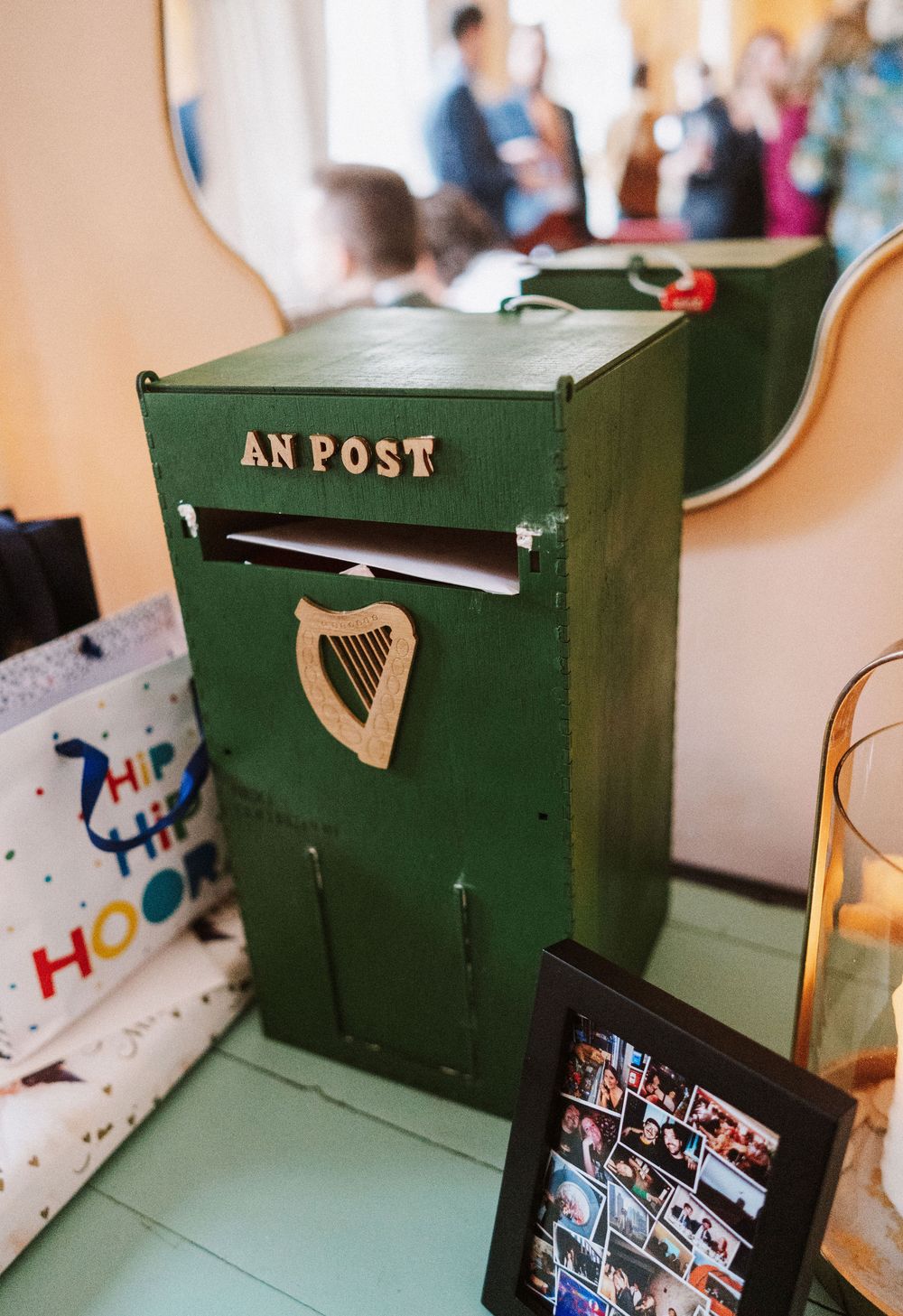 A traditional green Irish post box with a harp emblem shown from multiple angles in a sequence of photos.