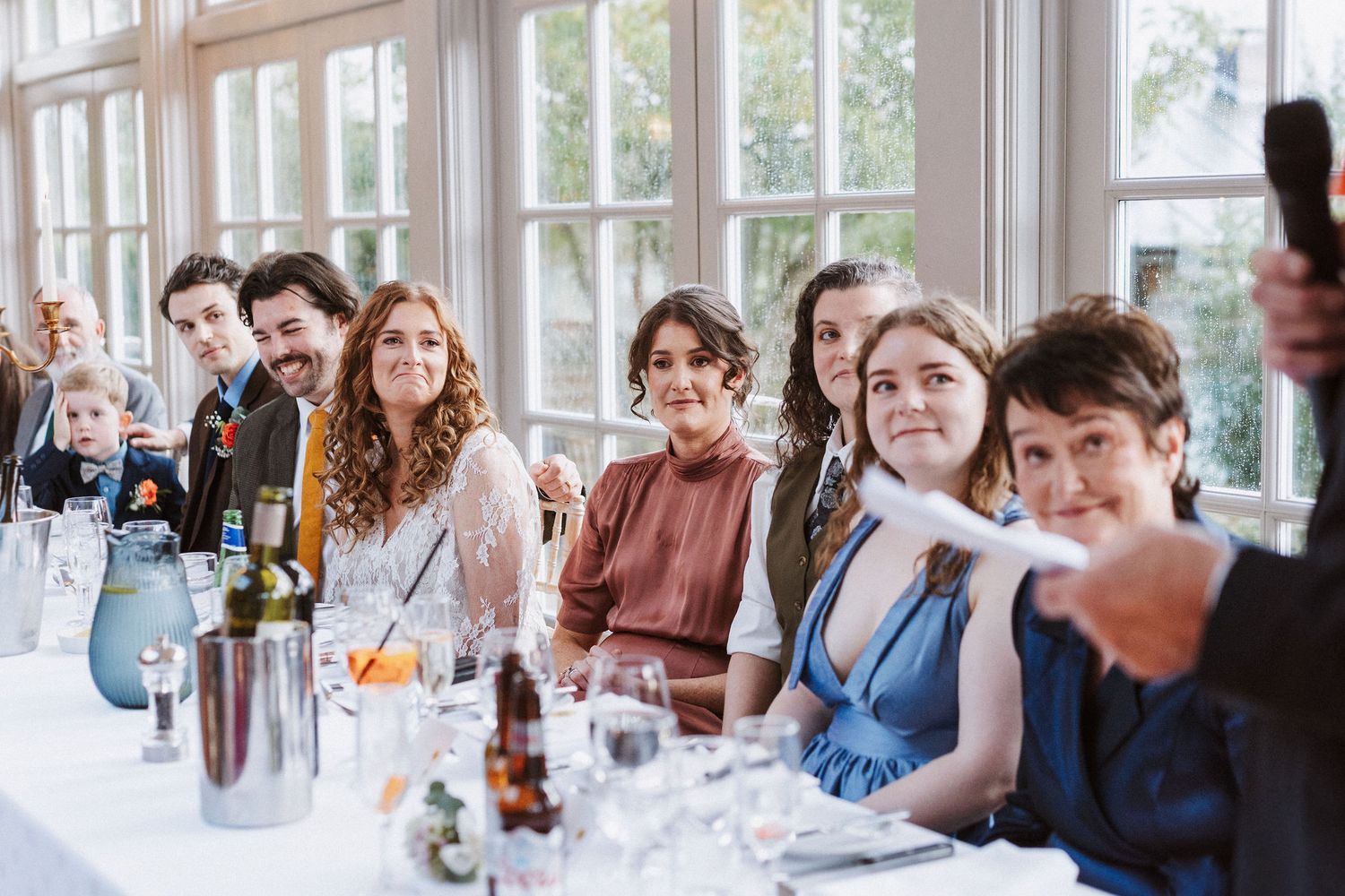 A series of candid social gathering photos showing people enjoying drinks and conversations in a bright indoor setting.