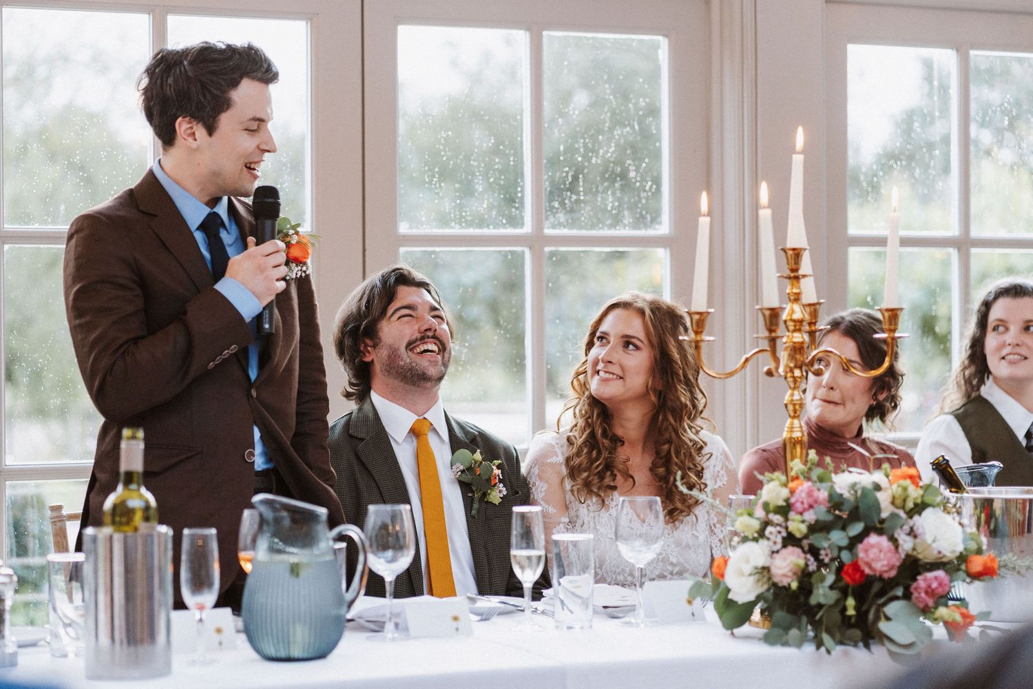 A panoramic collage of candid moments at an elegant wedding reception with guests dining and socializing in a bright venue.