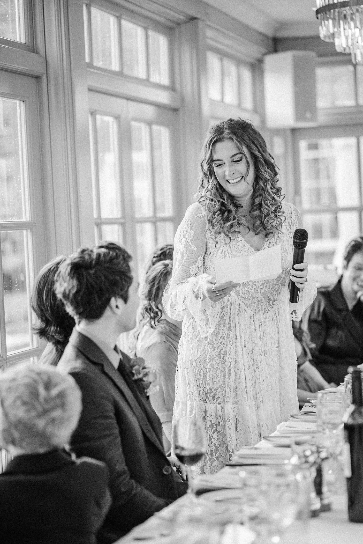 A series of black and white wedding reception photos showing guests seated at tables with elegant chandeliers overhead.