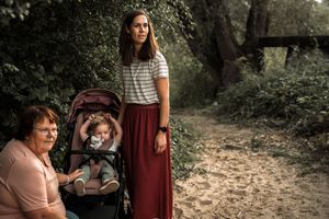 A series of connected outdoor family portrait photos taken in a wooded setting with natural lighting and earth-toned clothing.