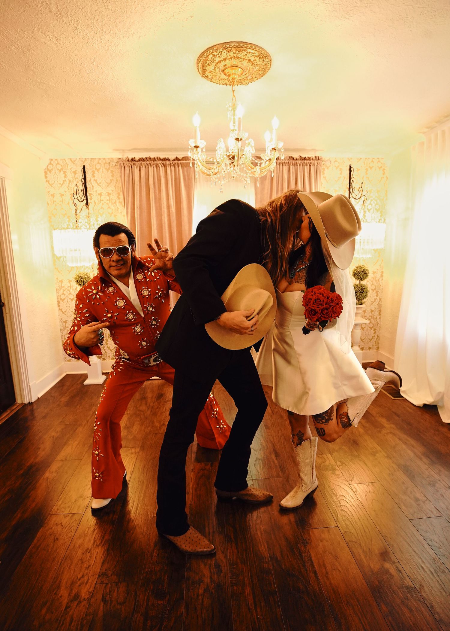 A sequence showing playful dance moves on a hardwood floor in an elegantly lit room.