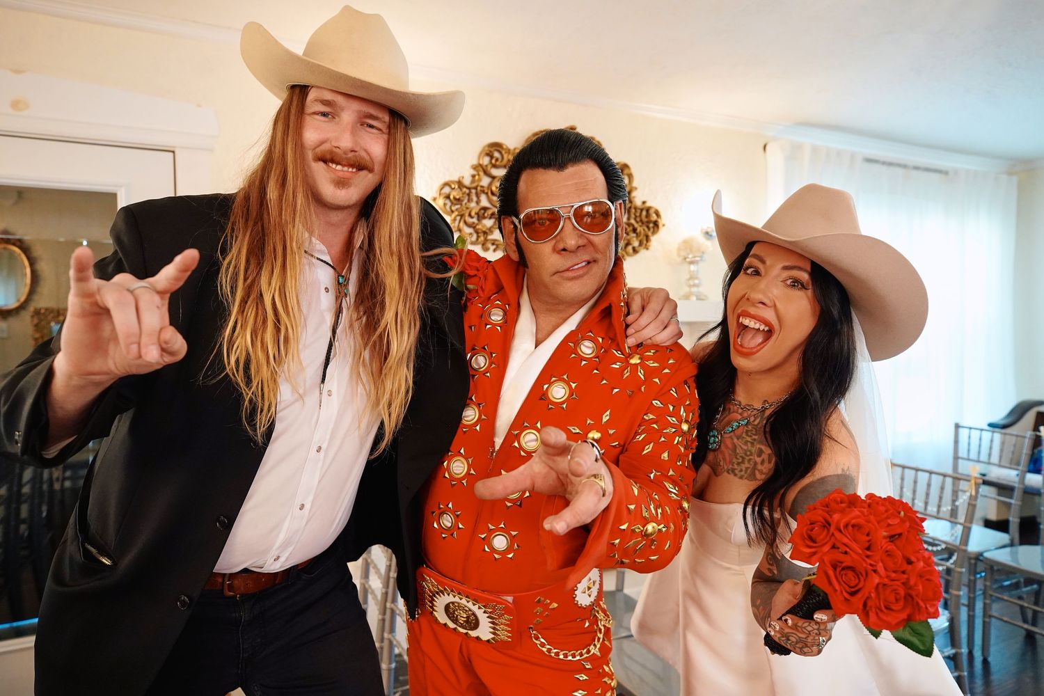 wedding in western and formal attire celebrate together in a brightly lit indoor setting with Elvis officiant at Rhinestone Chapel Nashville