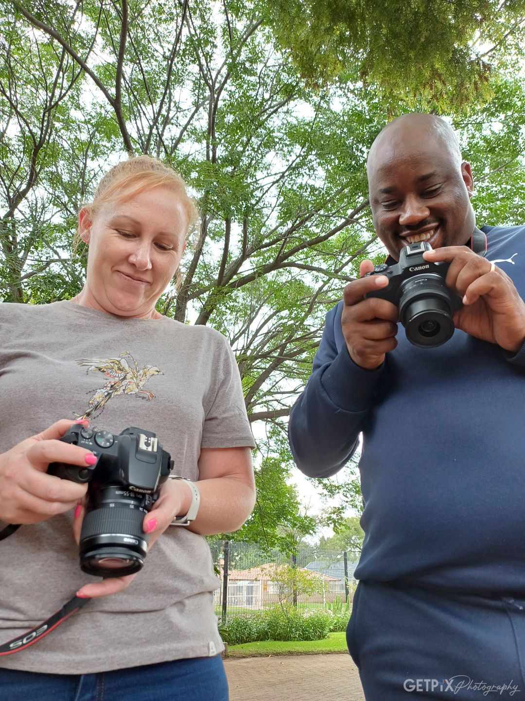 Photography students on a short photographic course in Benoni at GETPIX Photography. They are looking at their images on their cameras.