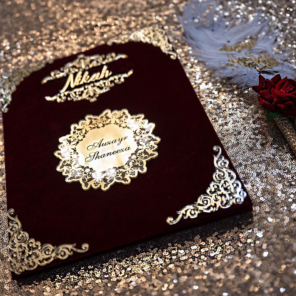 Ornate dark velvet Nikah ceremony book with gold embossed names Awais and Maneesa.