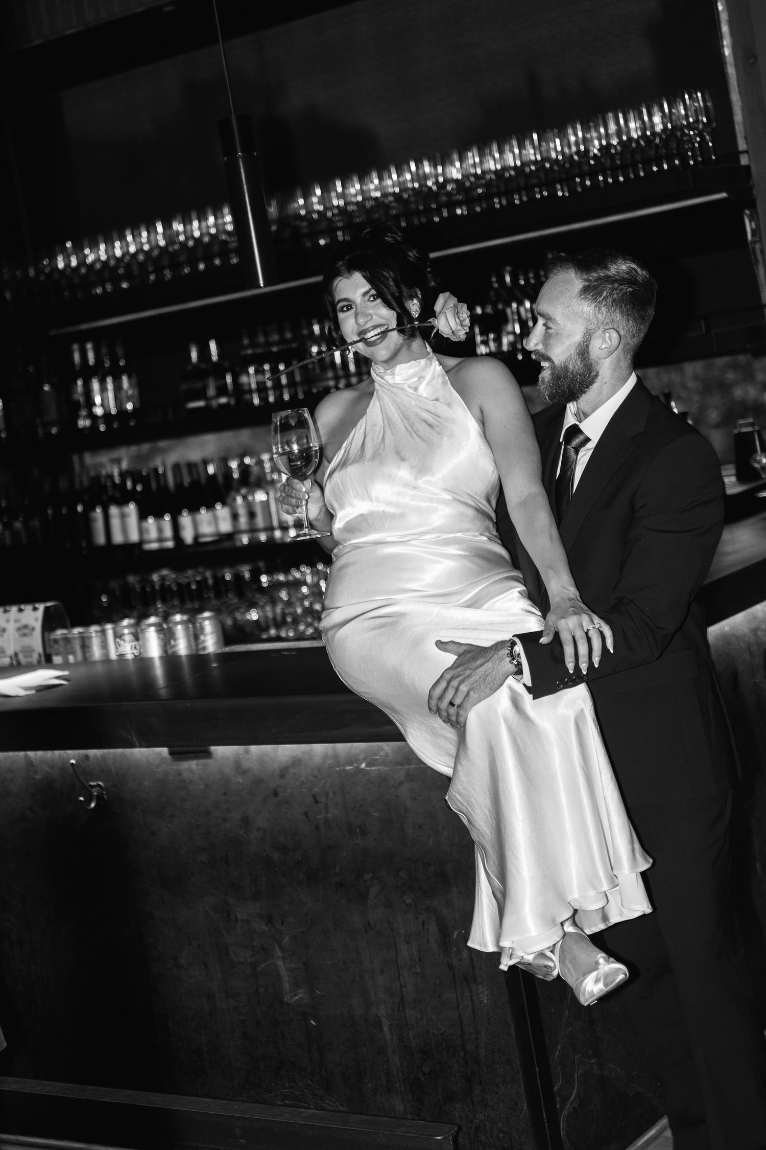 A romantic dance scene in a dimly lit bar with white satin dress flowing.
