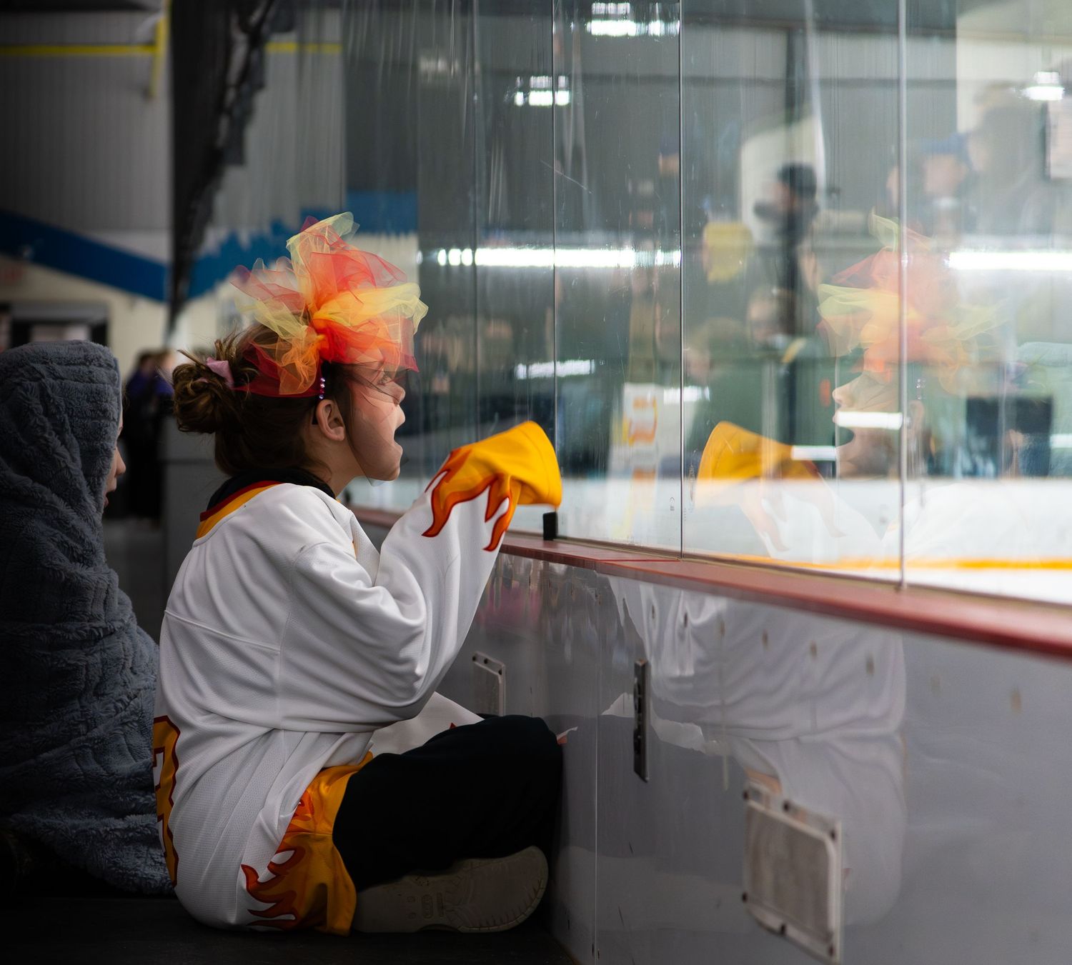 young fan cheering for the ringette players