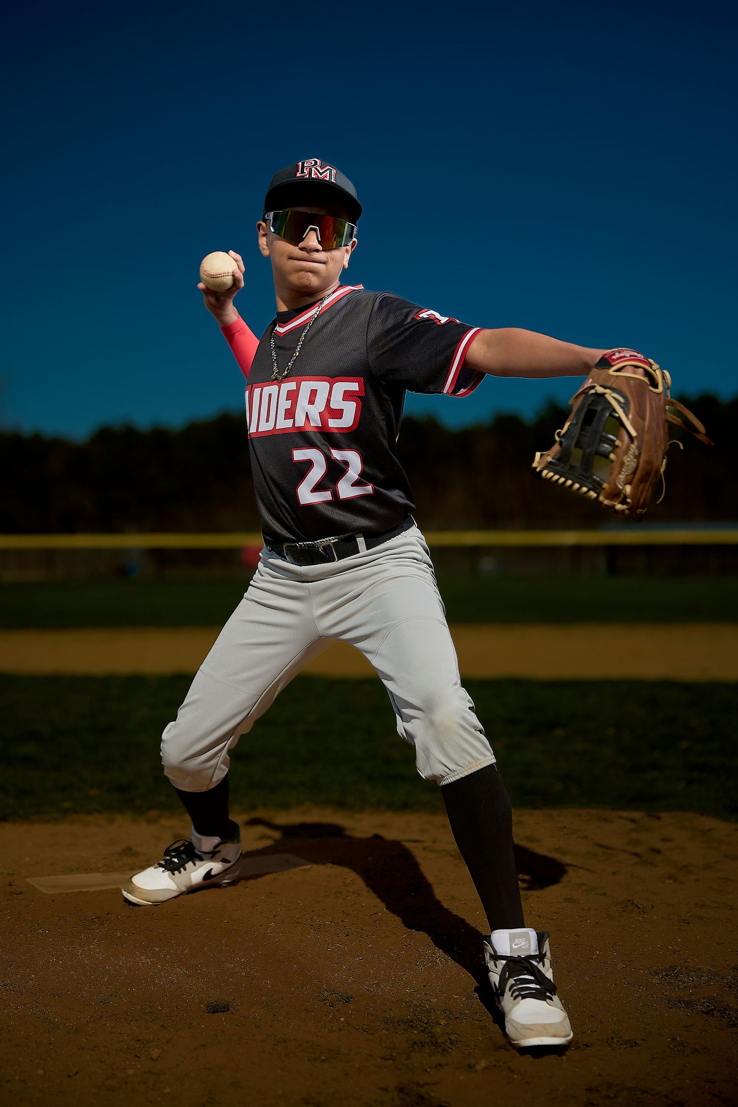 A row of sports team photos showing players in black and red uniforms with Raider team branding.