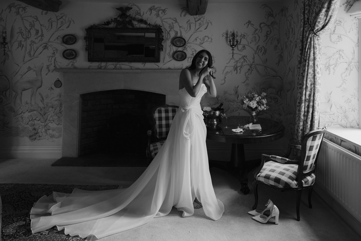 bride fastening earrings at dewsall court in herefordshire