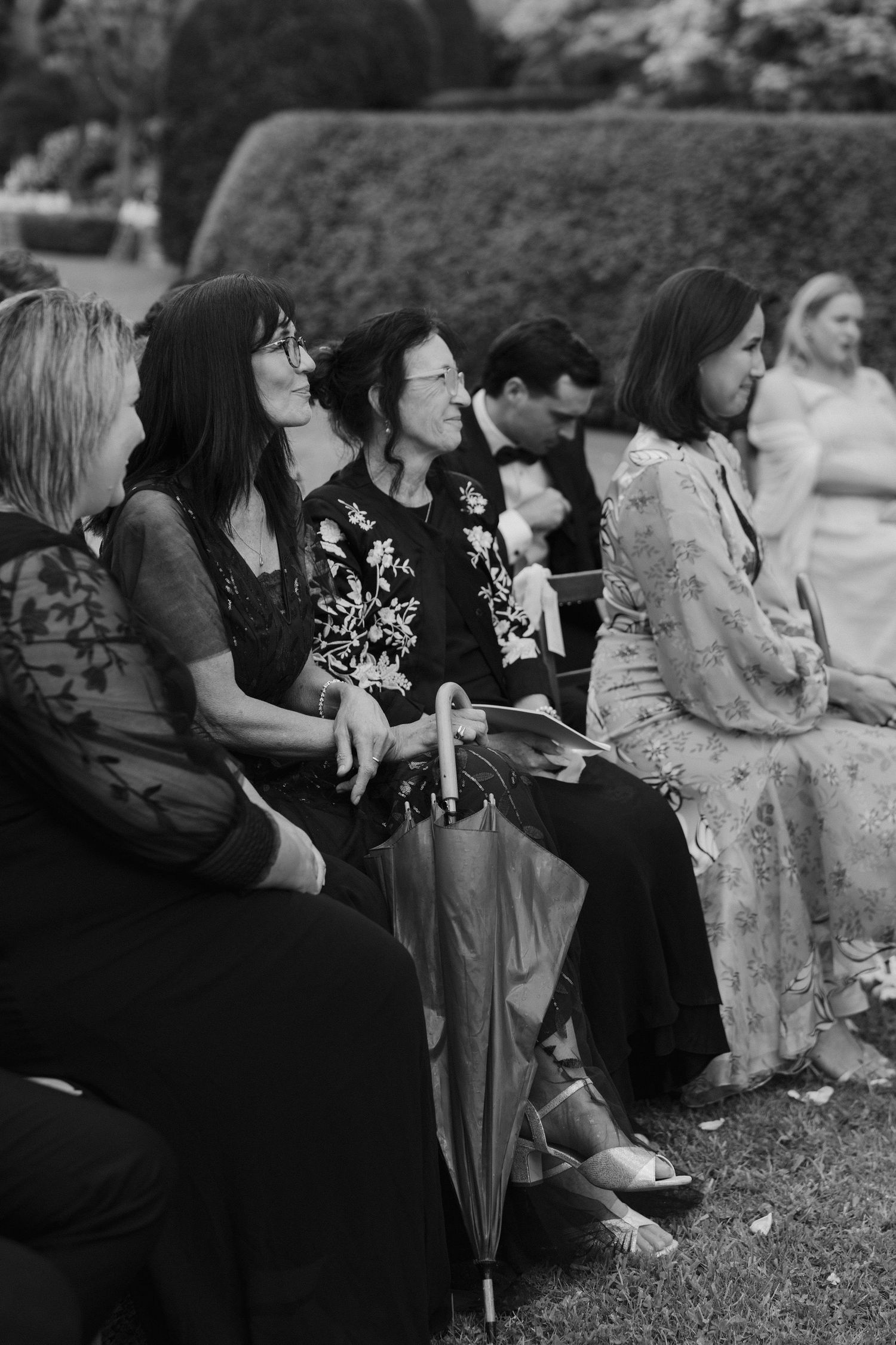 wedding guests smiling emotionally at bride and groom during wedding ceremony at dewsall court in herefordshire