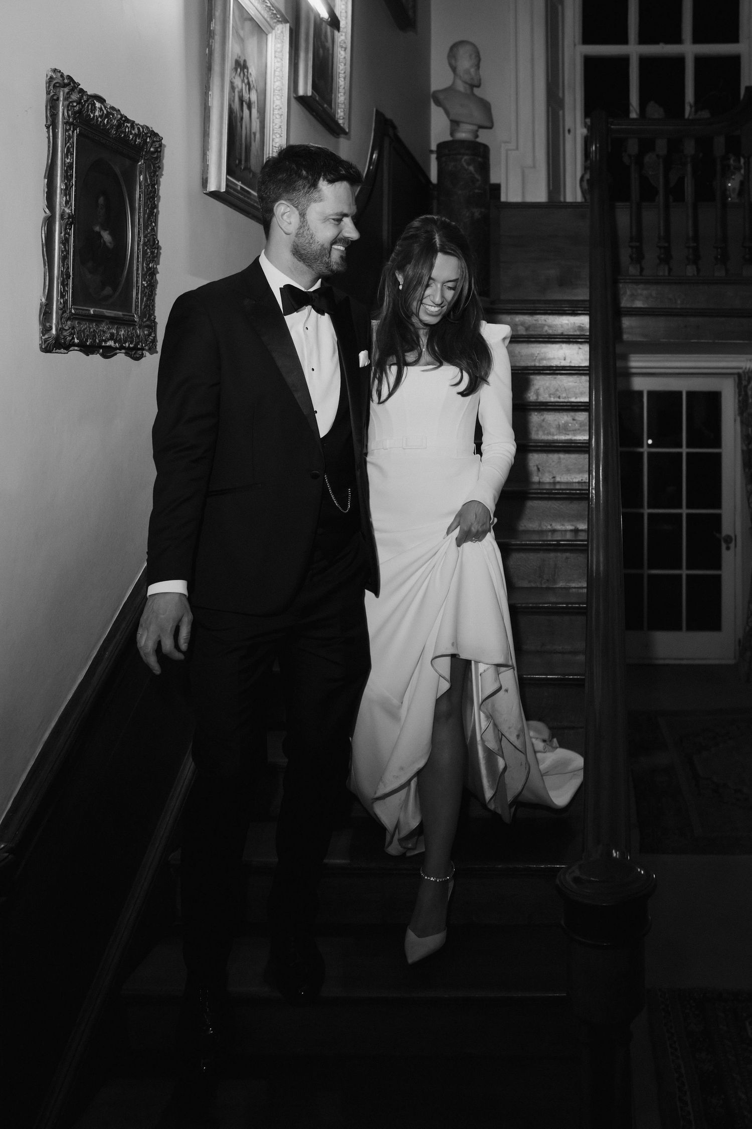 groom leading bride down stairs at Iscoyd park