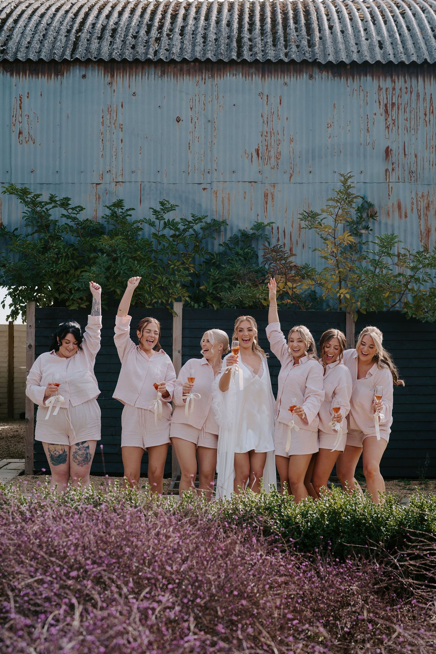 bride and bridesmaids dancing and drinking champagne at ivy lodge in cirencester