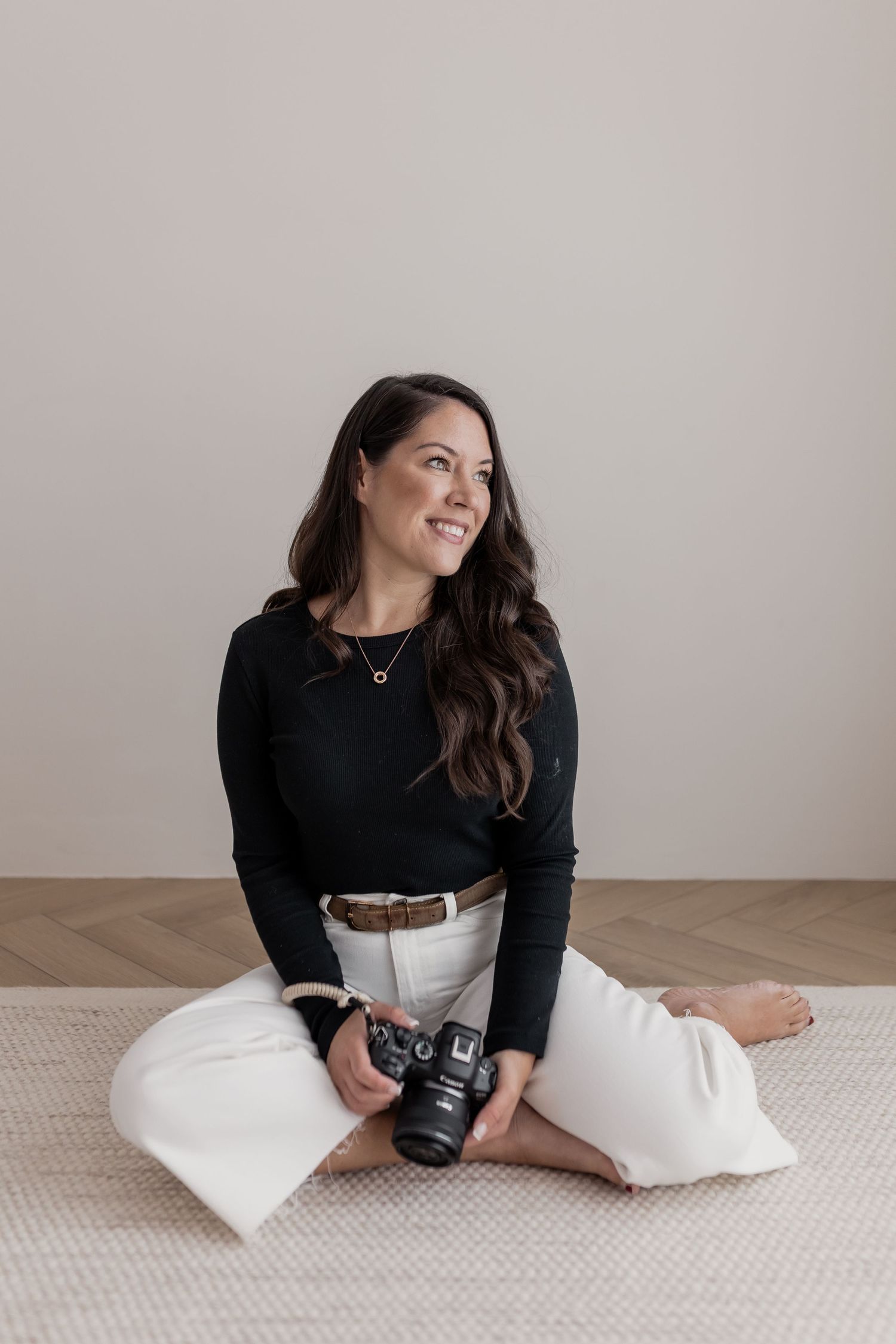 Candid photography session with camera on neutral carpet against white wall. Photography in Buckinghamshire.