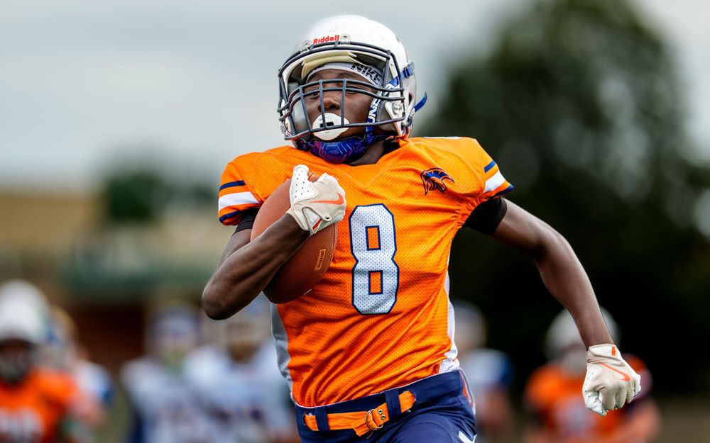 CFA Youth Football League team youth athlete running with football in Hershey PA, SportsFox Photography.