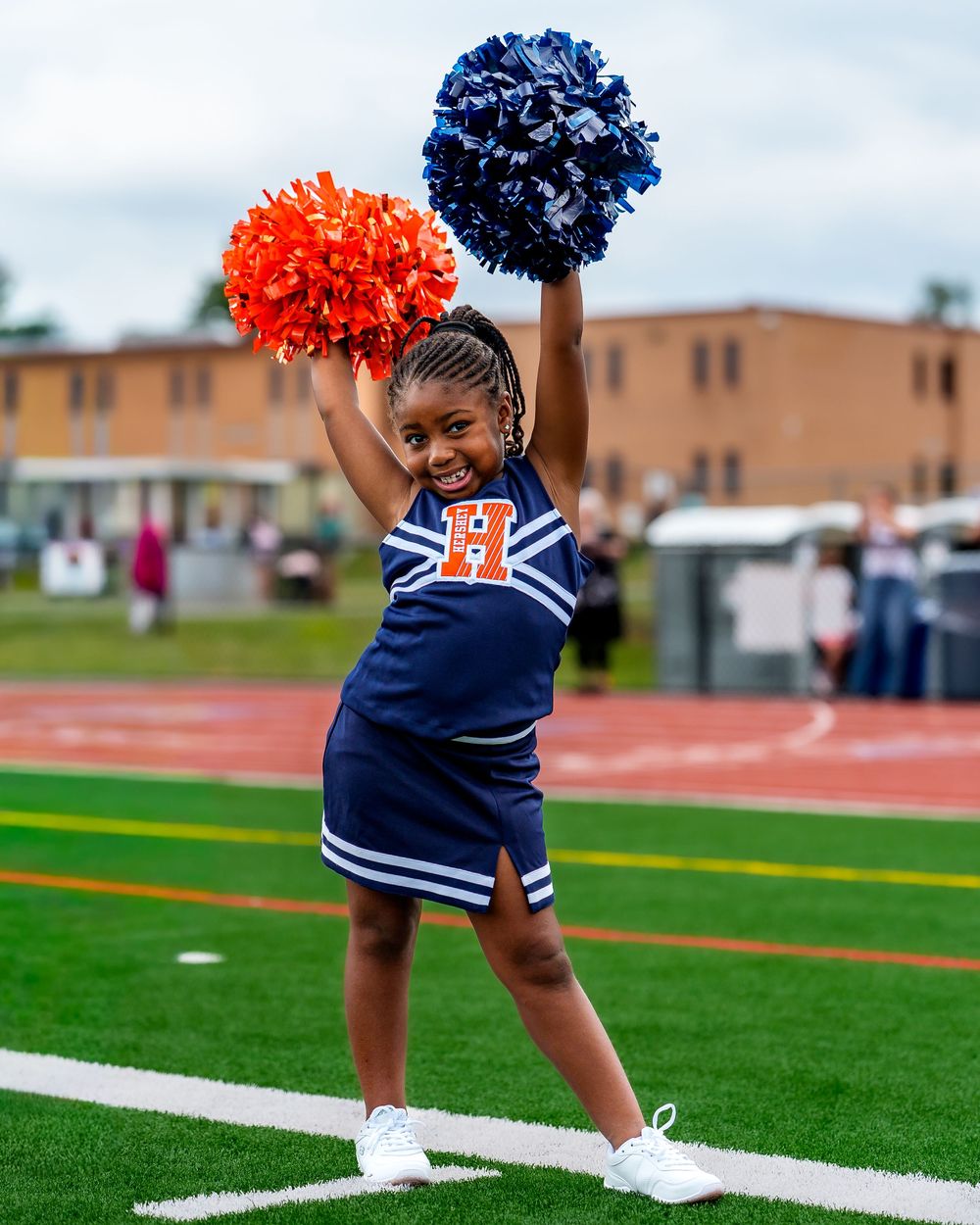 CFA Youth Football League cheer young athlete holding smiling outdoors in Hershey PA, SportsFox Photography.