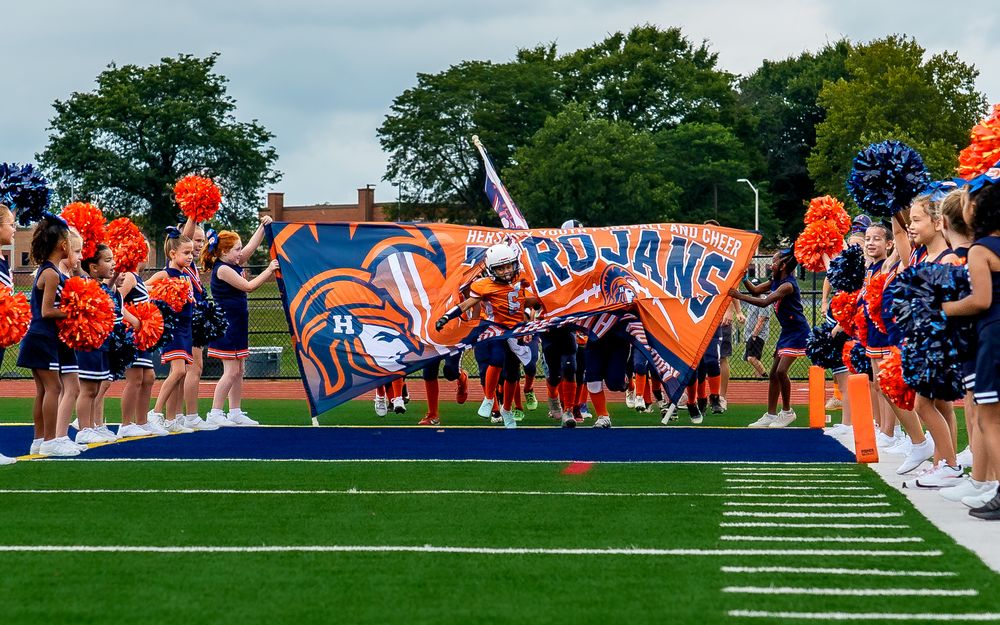 CFA Youth Football League team youth athletes running through team banner in Hershey PA, SportsFox Photography.