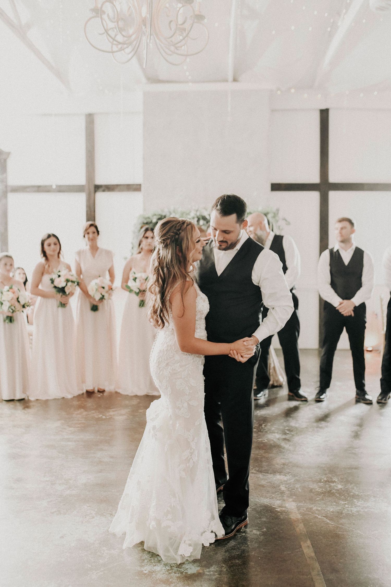 Emotional candid portrait of the newlyweds connecting during their outdoor spring wedding during their first dance